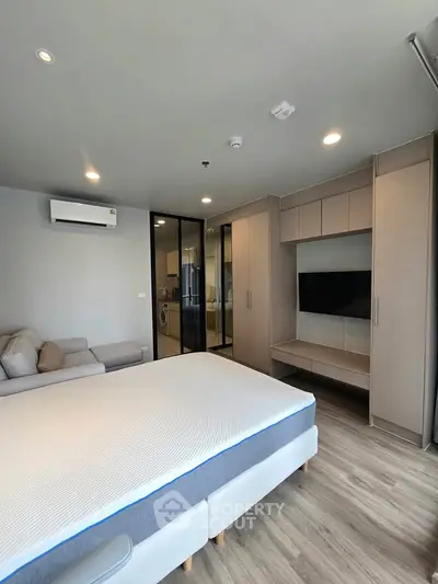 Modern bedroom with sleek design, featuring built-in storage and a cozy ambiance.