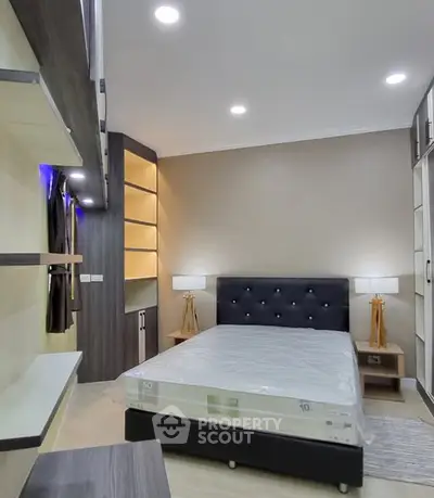 Modern bedroom with stylish shelving and ambient lighting