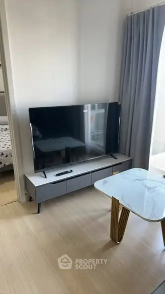 Modern living room with sleek TV setup and elegant marble coffee table