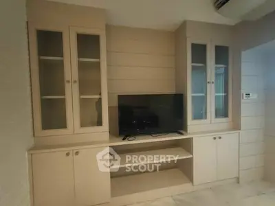 Modern living room with built-in cabinets and flat-screen TV