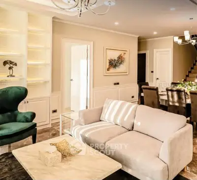 Luxurious living room with elegant decor and dining area, featuring plush seating and ambient lighting.