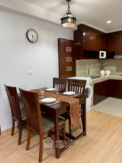 Charming dining area with elegant wooden furniture and modern kitchen appliances.