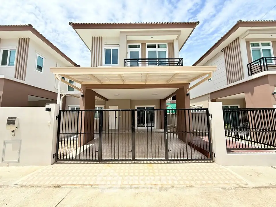 Modern two-story house with gated driveway and contemporary design
