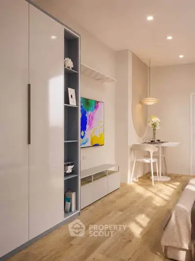 Modern living room with sleek storage and vibrant artwork, featuring elegant lighting and cozy dining nook.