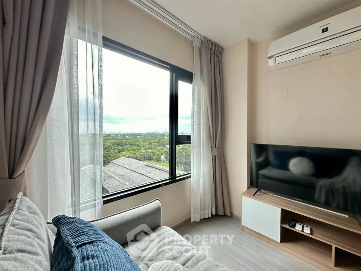 Modern living room with large window offering stunning city view, cozy sofa, and sleek TV setup.