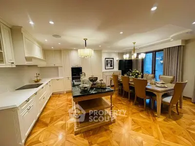 Luxurious open-layout kitchen with elegant dining area and stylish parquet flooring.