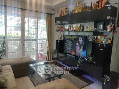 Stylish living room with modern entertainment setup and large windows for natural light.