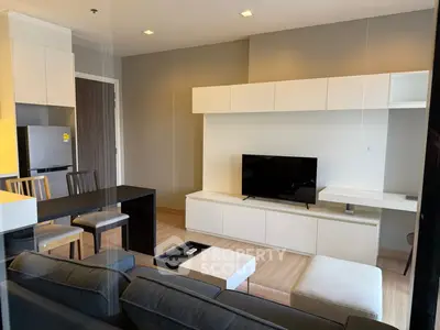 Modern living room with sleek furniture and open kitchen layout