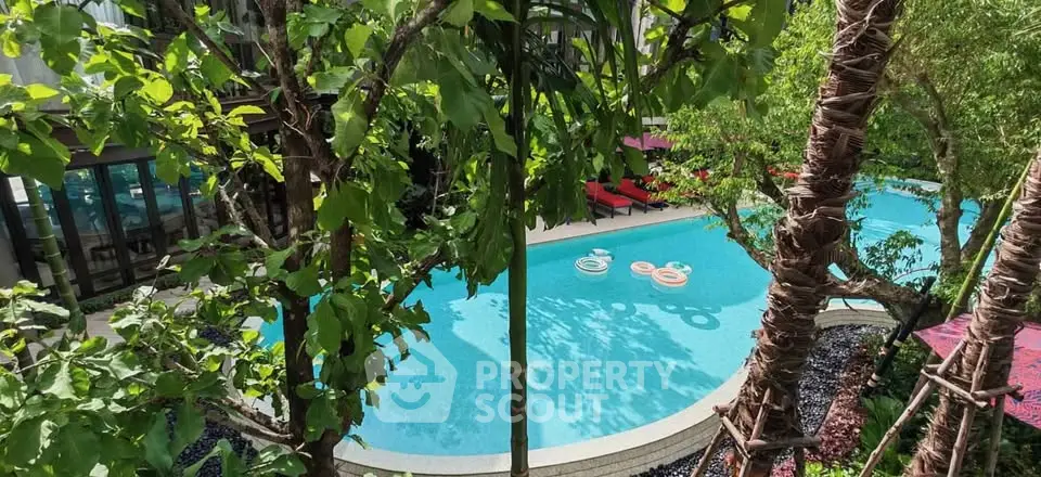 Luxurious outdoor pool surrounded by lush greenery, perfect for relaxation and leisure.
