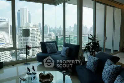Luxurious living room with panoramic city view and modern furnishings.