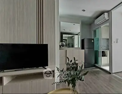 Modern apartment interior with sleek kitchen and cozy living area, featuring contemporary design and efficient layout.