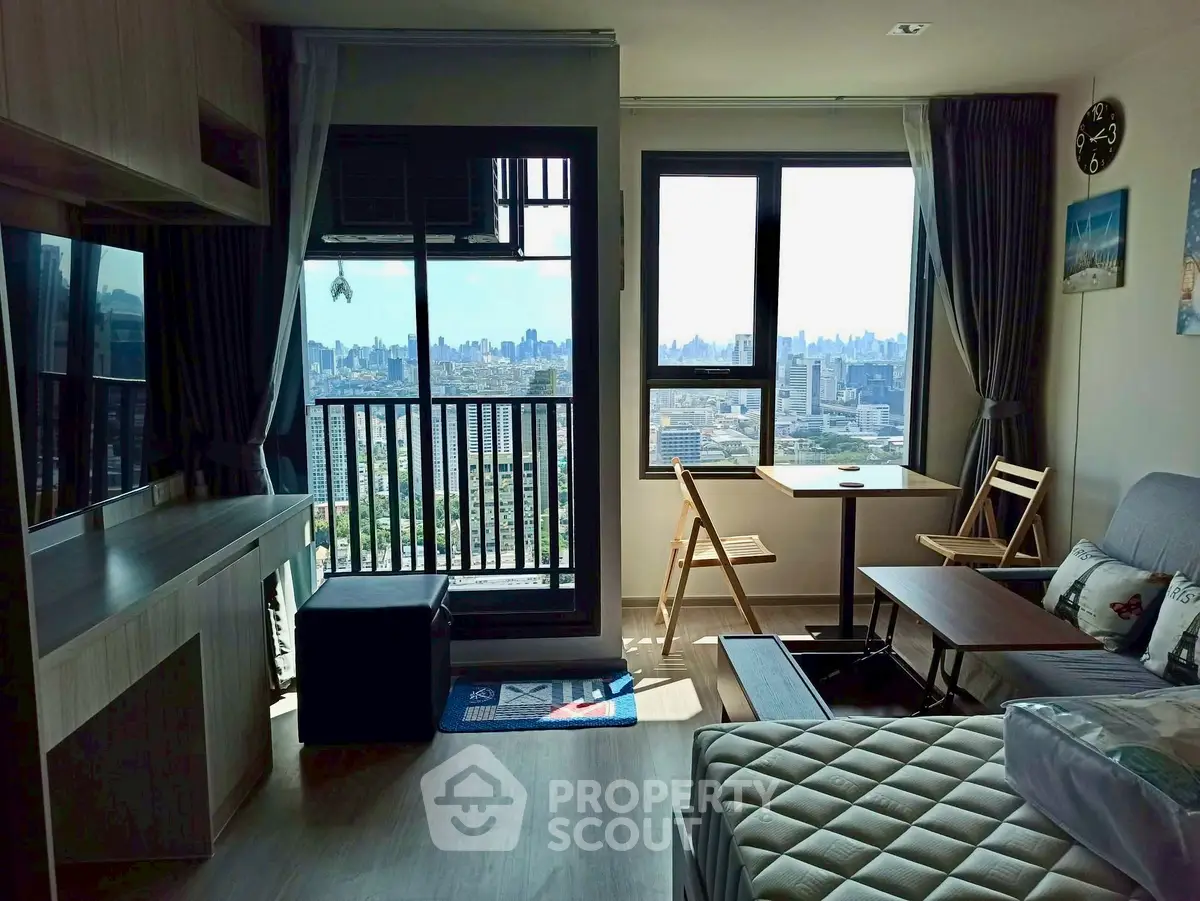 Modern living room with city view, featuring cozy seating and natural light.