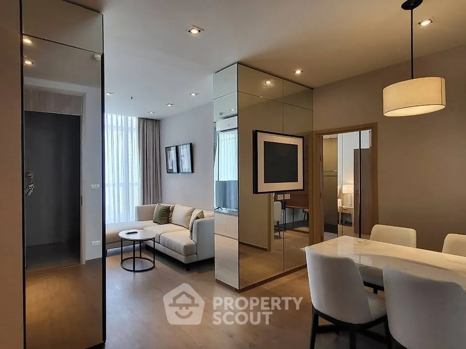 Modern living room with dining area and stylish decor in a contemporary apartment.