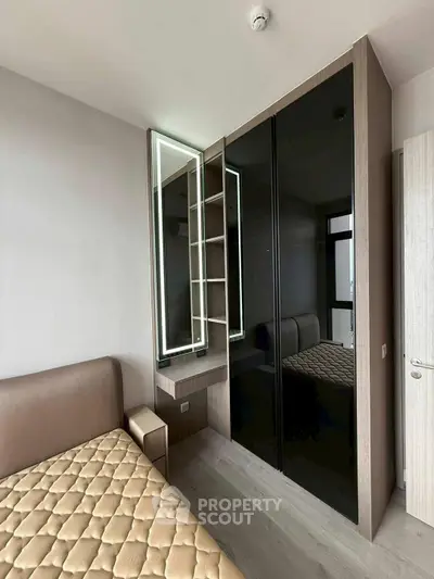 Modern bedroom with sleek wardrobe and stylish bed in contemporary apartment.