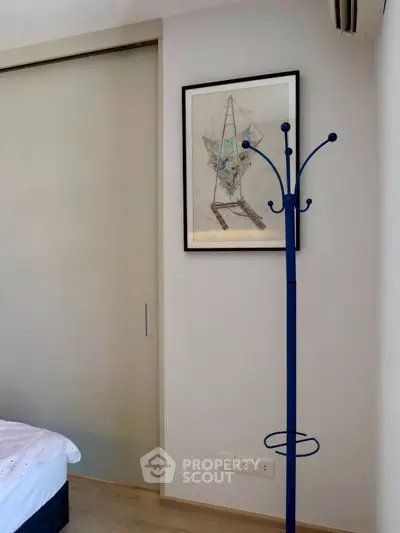 Modern bedroom corner with sliding door and stylish coat rack