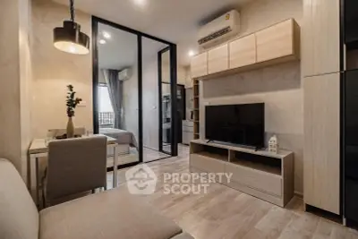 Modern living room with sleek design and open layout, featuring a cozy bedroom view.