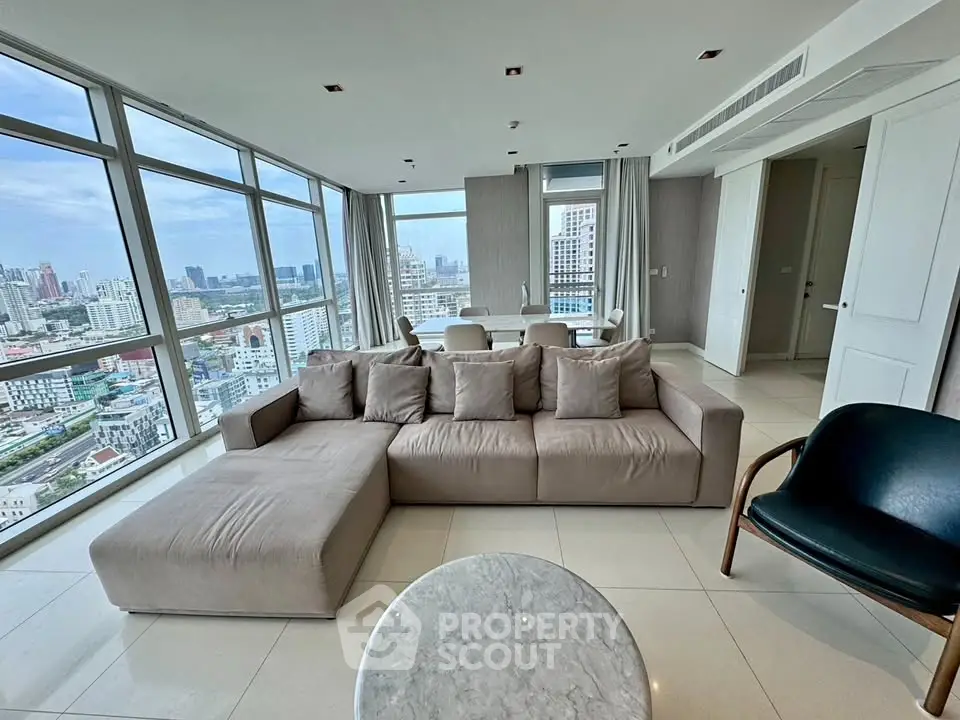 Luxurious corner unit living room with panoramic city views and modern furnishings.