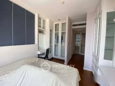 Spacious bedroom with modern built-in wardrobes and study desk