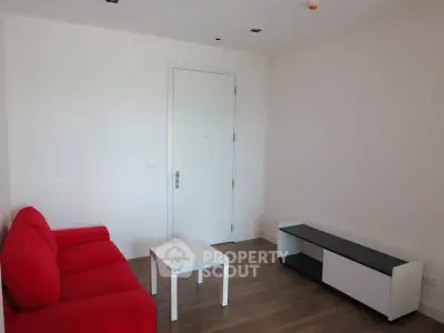 Minimalist living room with red sofa and modern furniture