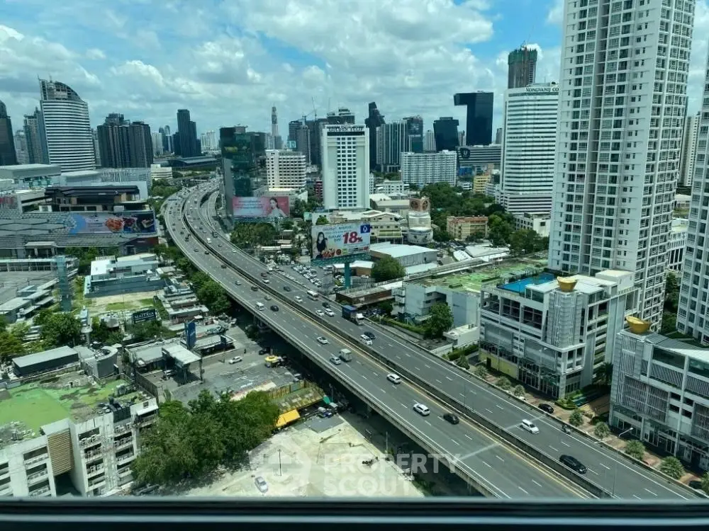 Stunning cityscape view from high-rise apartment window showcasing urban skyline and bustling highway.