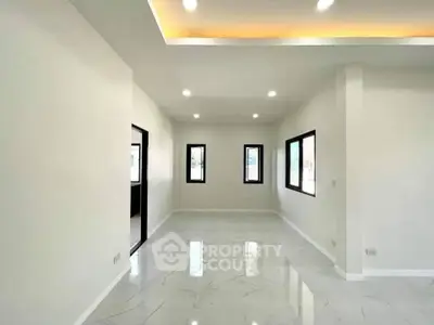 Spacious modern living room with elegant lighting and large windows