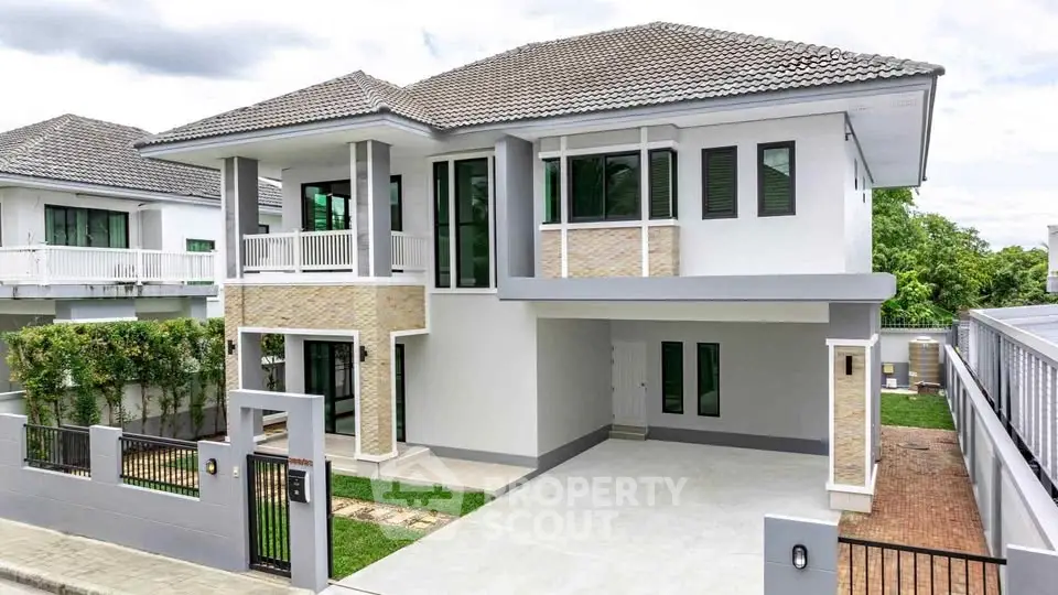 Modern two-story house with spacious driveway and lush greenery