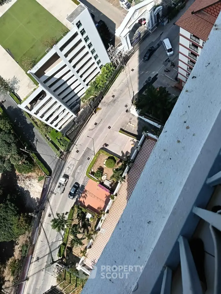 Stunning aerial view from high-rise balcony overlooking urban landscape and modern buildings.