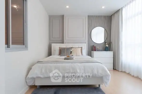 Elegant bedroom with modern decor and natural light