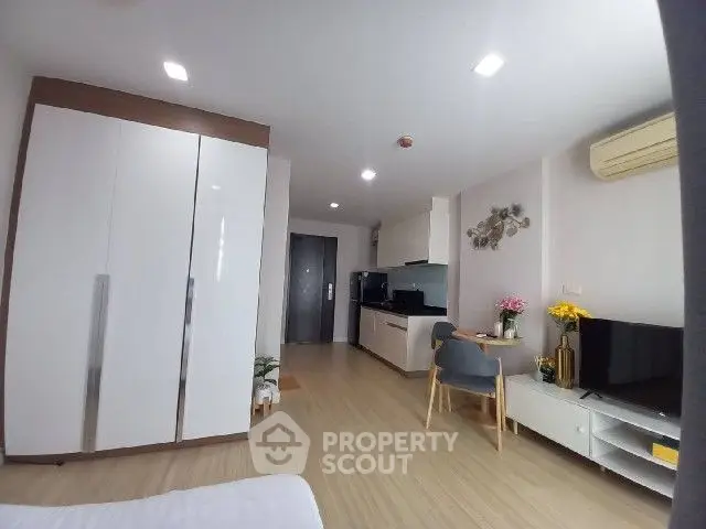 Modern studio apartment with sleek kitchen and cozy living area