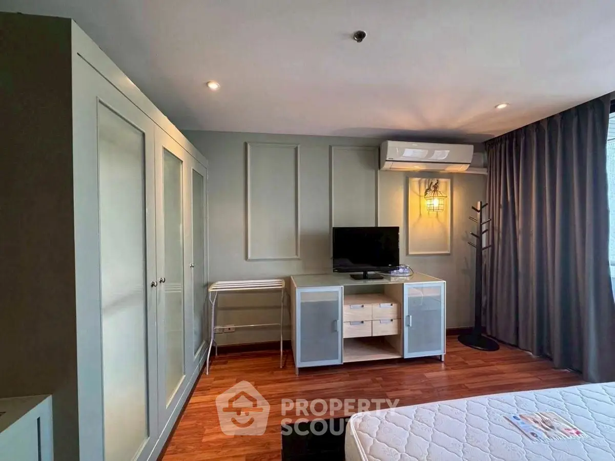 Stylish bedroom with modern furniture and air conditioning in a cozy apartment.