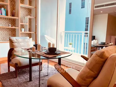Chic living room with modern decor and balcony view, perfect for urban living.