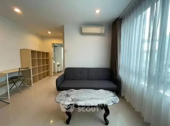 Modern living room with elegant sofa and large window offering natural light