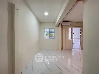 Spacious interior with marble flooring and natural light, ideal for modern living.