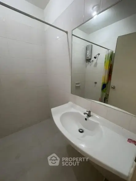 Spacious bathroom with modern sink and large mirror in a contemporary apartment.