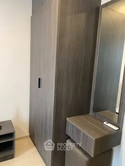 Modern wooden wardrobe with built-in mirror in stylish apartment interior