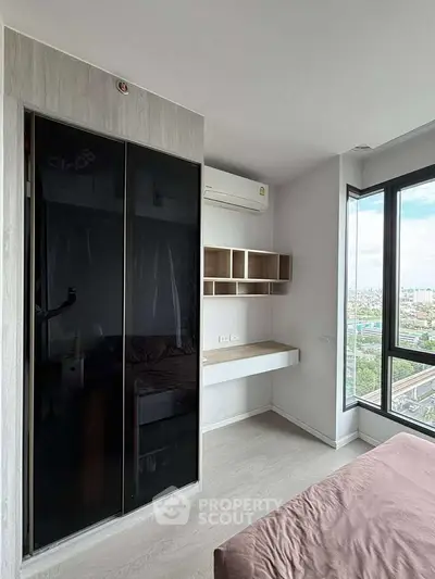 Modern bedroom with built-in wardrobe and city view, featuring sleek design and natural light.