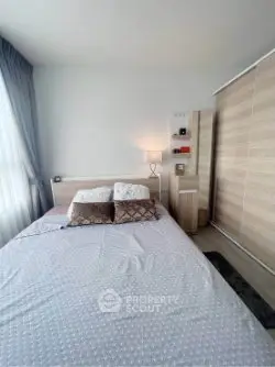Cozy bedroom with modern decor and ample natural light