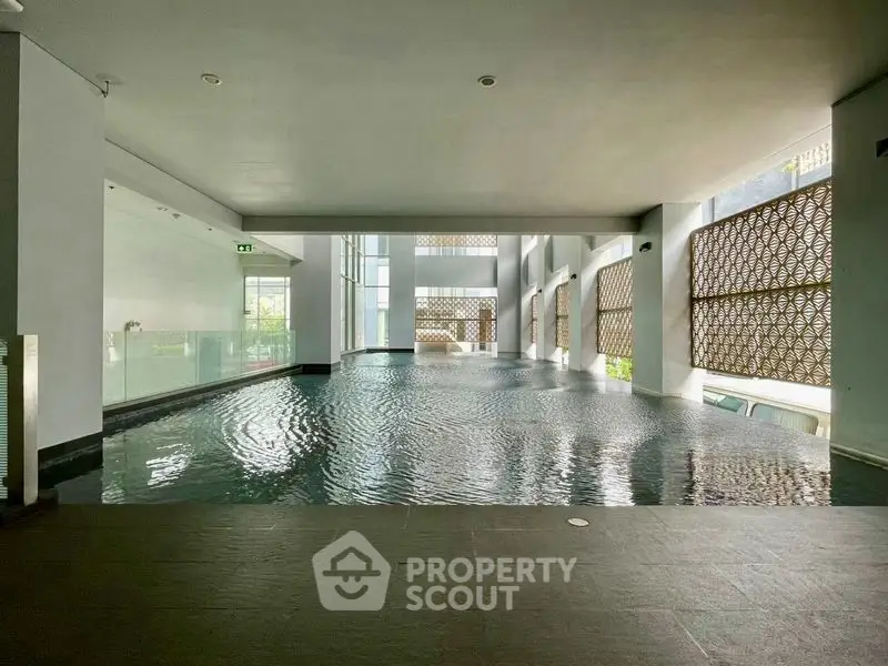 Luxurious indoor pool with modern design and ample natural light