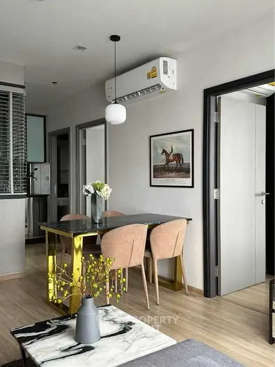 Modern living room with stylish decor and dining area in a cozy apartment.