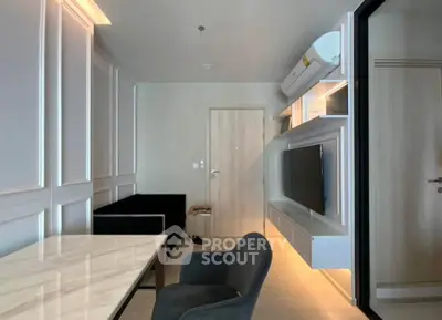 Modern living room with sleek furniture and wall-mounted TV in a stylish apartment.