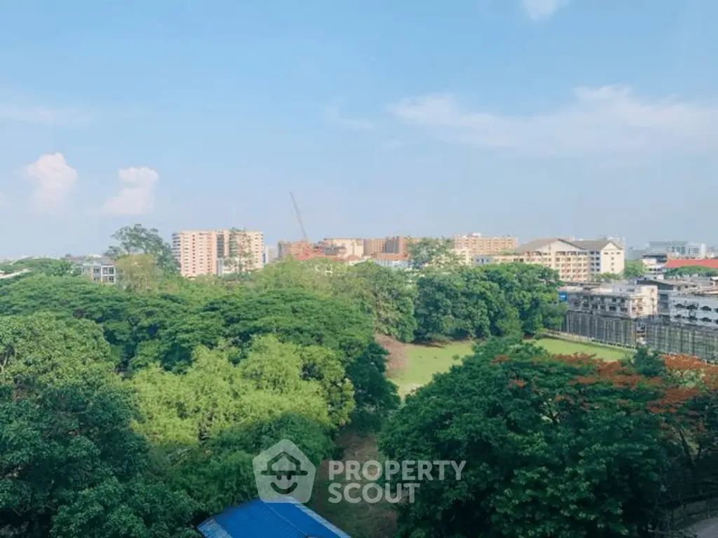 Scenic view of lush greenery and cityscape from a high vantage point, ideal for urban nature lovers.