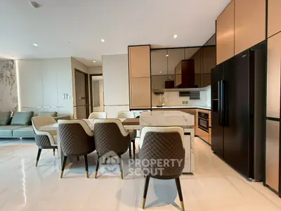 Luxurious open-plan kitchen and dining area with modern furnishings and sleek design.