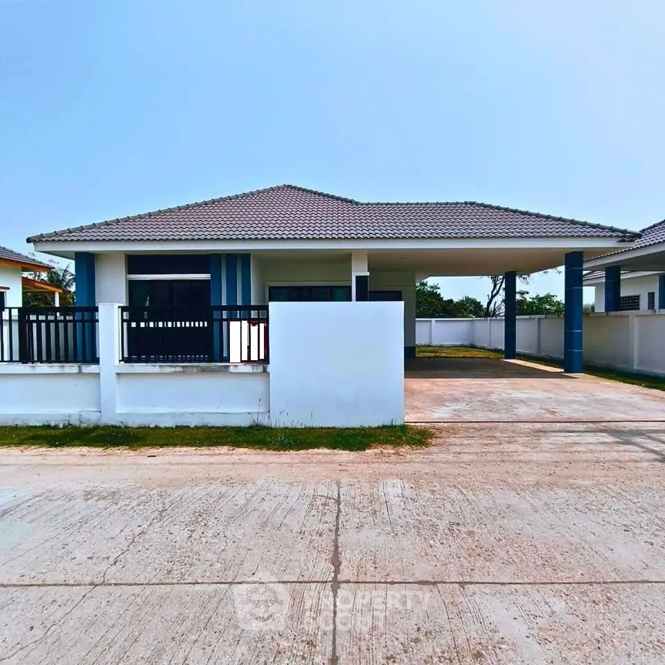 Charming single-story home with modern design and spacious driveway in a serene neighborhood.