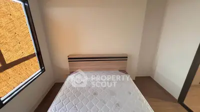 Cozy bedroom with natural light and minimalist design, perfect for relaxation.