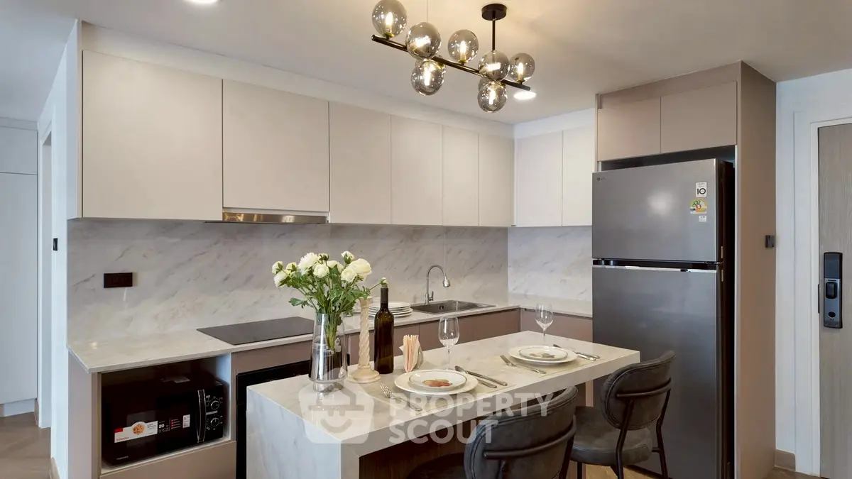 Modern kitchen with sleek design, featuring marble countertops and stylish lighting, perfect for culinary enthusiasts.