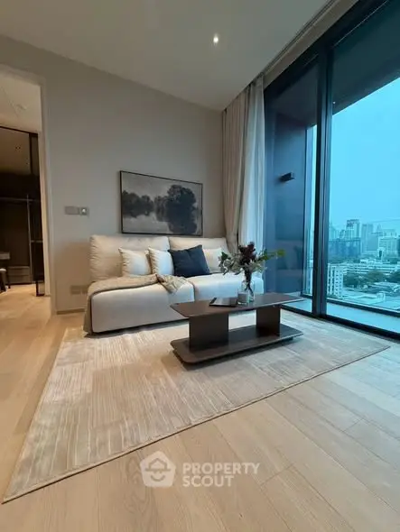 Modern living room with city view, featuring elegant decor and large windows.