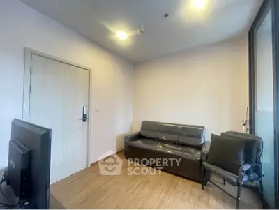Cozy living room with modern furniture and wooden flooring, perfect for relaxation.