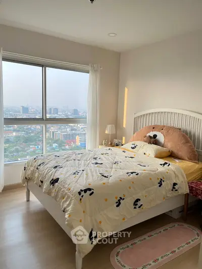 Cozy bedroom with large window offering stunning city view, featuring stylish decor and ample natural light.