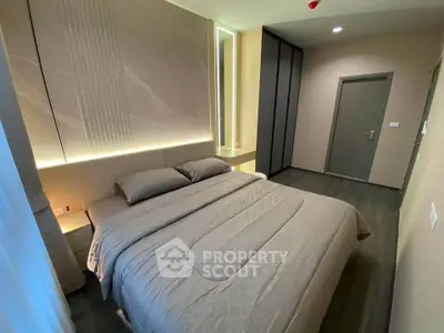 Modern bedroom with elegant lighting and sleek design, featuring a comfortable bed and stylish decor.
