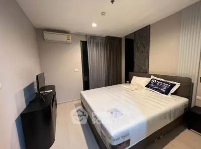 Modern bedroom with sleek design and air conditioning in a stylish apartment.